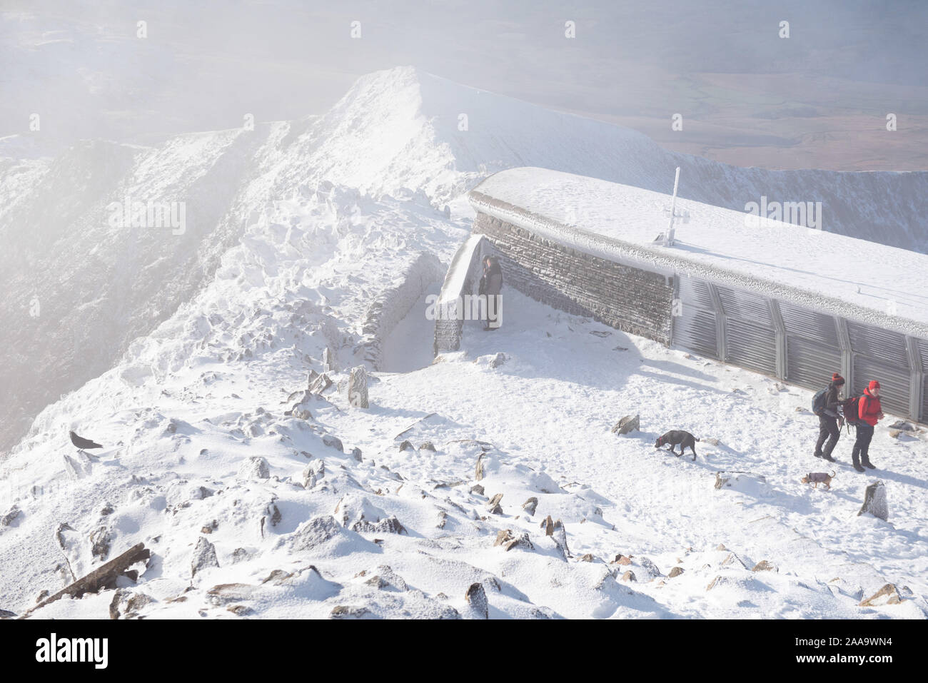 Snowdon Summit, Gwynedd, Wales, UK. 10th November 2019. Walkers brave the ice and snow to reach the summit of Snowdon in North Wales. Stock Photo