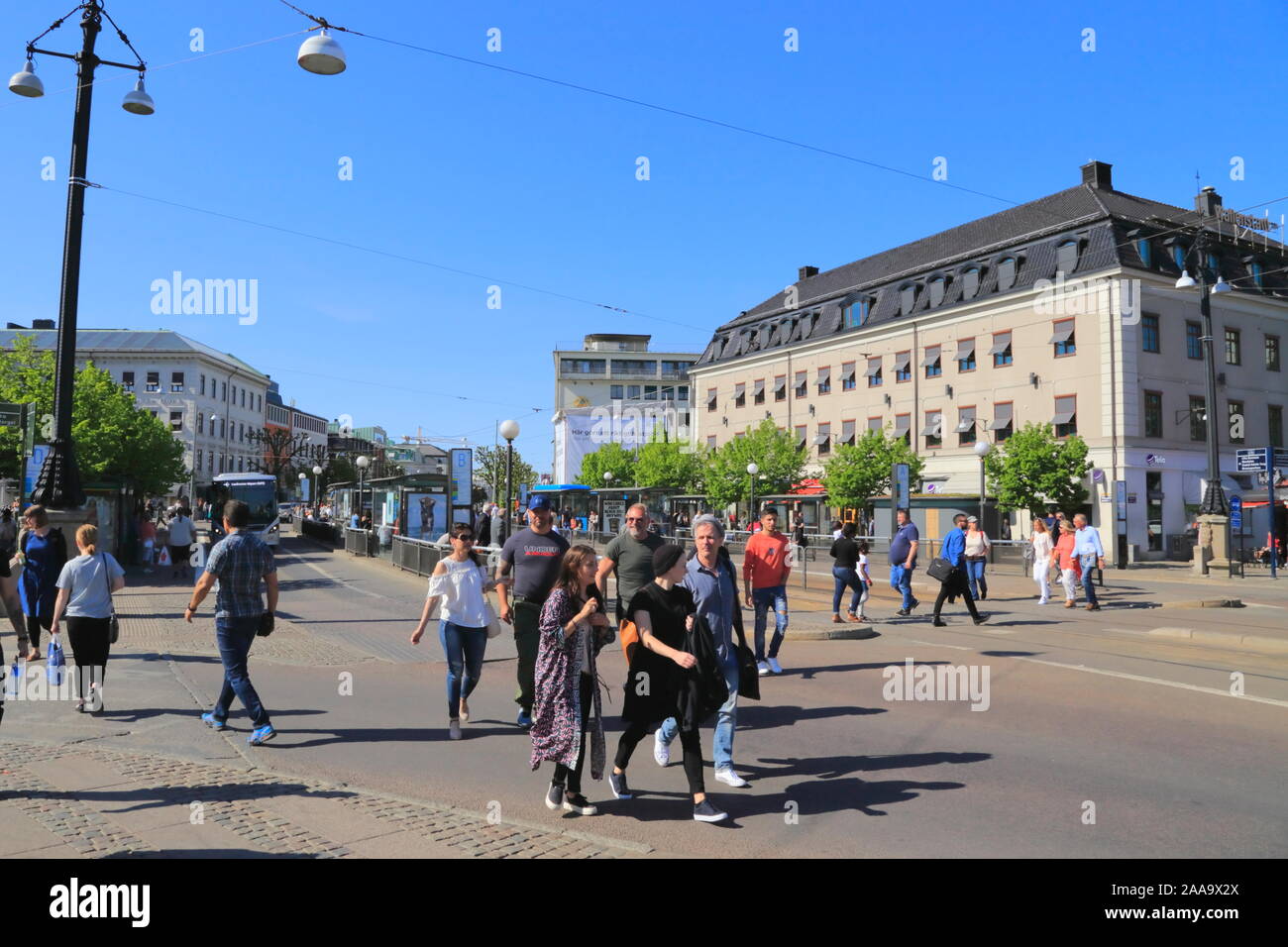 Pedestrians cross the street in Gothenburg city centre in Sweden, during the summer. Stock Photo