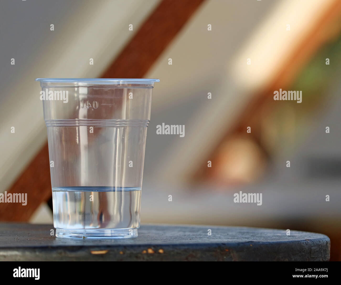 transparent plastic cup of water on table with copy space Stock Photo
