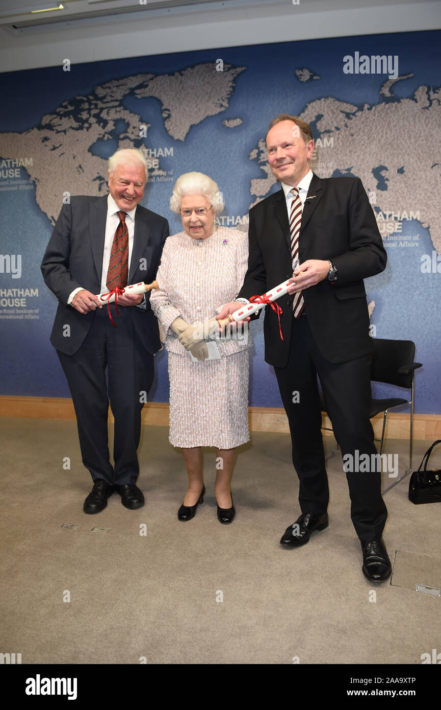 Queen Elizabeth II presents the Chatham House Prize 2019 to Sir David Attenborough (left) and Julian Hector, Head of the BBC Natural History Unit, at the Royal institute of International Affairs, Chatham House, London. Stock Photo