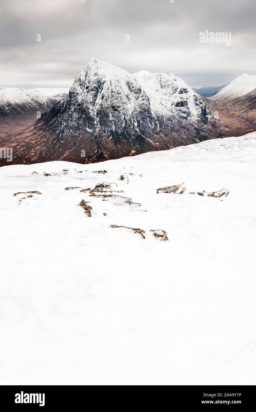 Scottish Highlands mountain landscape in winter Buachaille Etive Mor from snow covered summit of  Beinn a Chrulaiste above Glen Coe Stock Photo