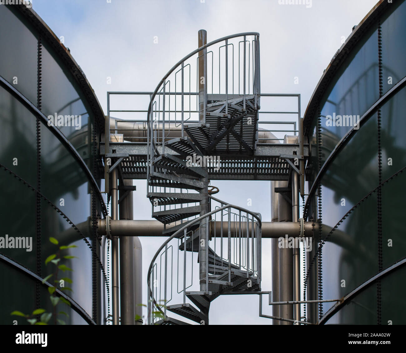 industry: winding stairs between two gas storage tanks Stock Photo