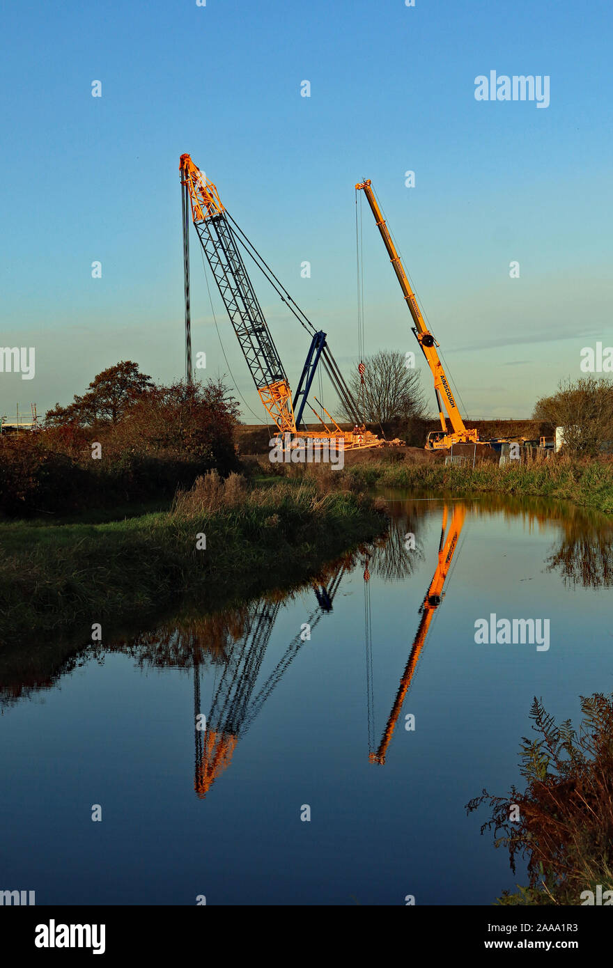 Ainscough’s crane hire company are busy building a large crane in a field next to the Leeds and Liverpool canal near Burscough in West Lancashire Stock Photo