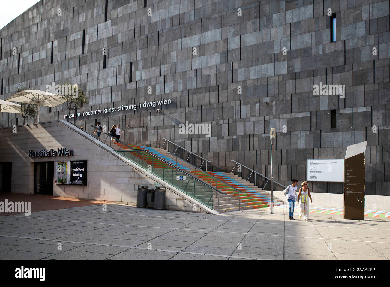 VIENNA, AUSTRIA - August 30, 2019: Viennese art pavilion and Mumok Museum. People listen to concerts, sitting on chairs, lying on purple benches. Stock Photo