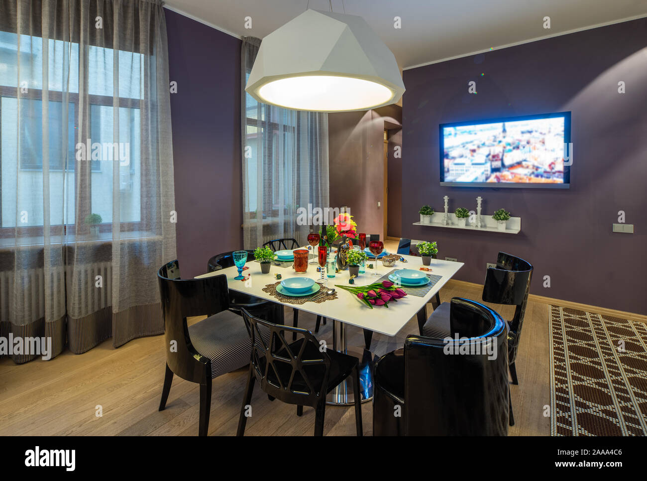 Modern interior of studio apartment. TV and set table. Living room Stock Photo Alamy