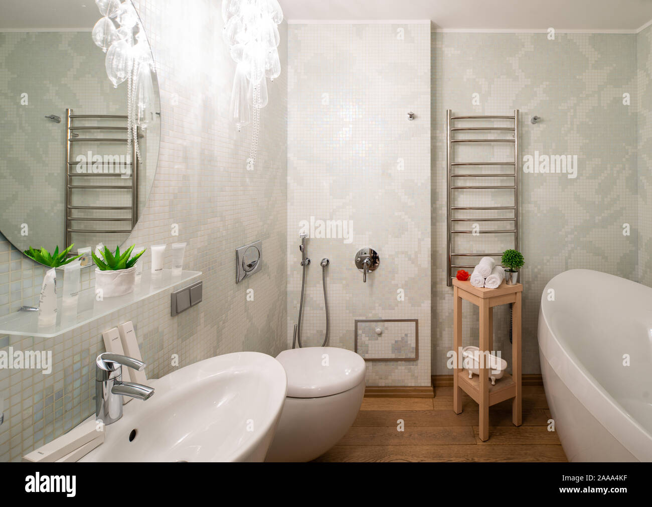 Interior of light bathroom in modern apartment. Bath, toilet and sink