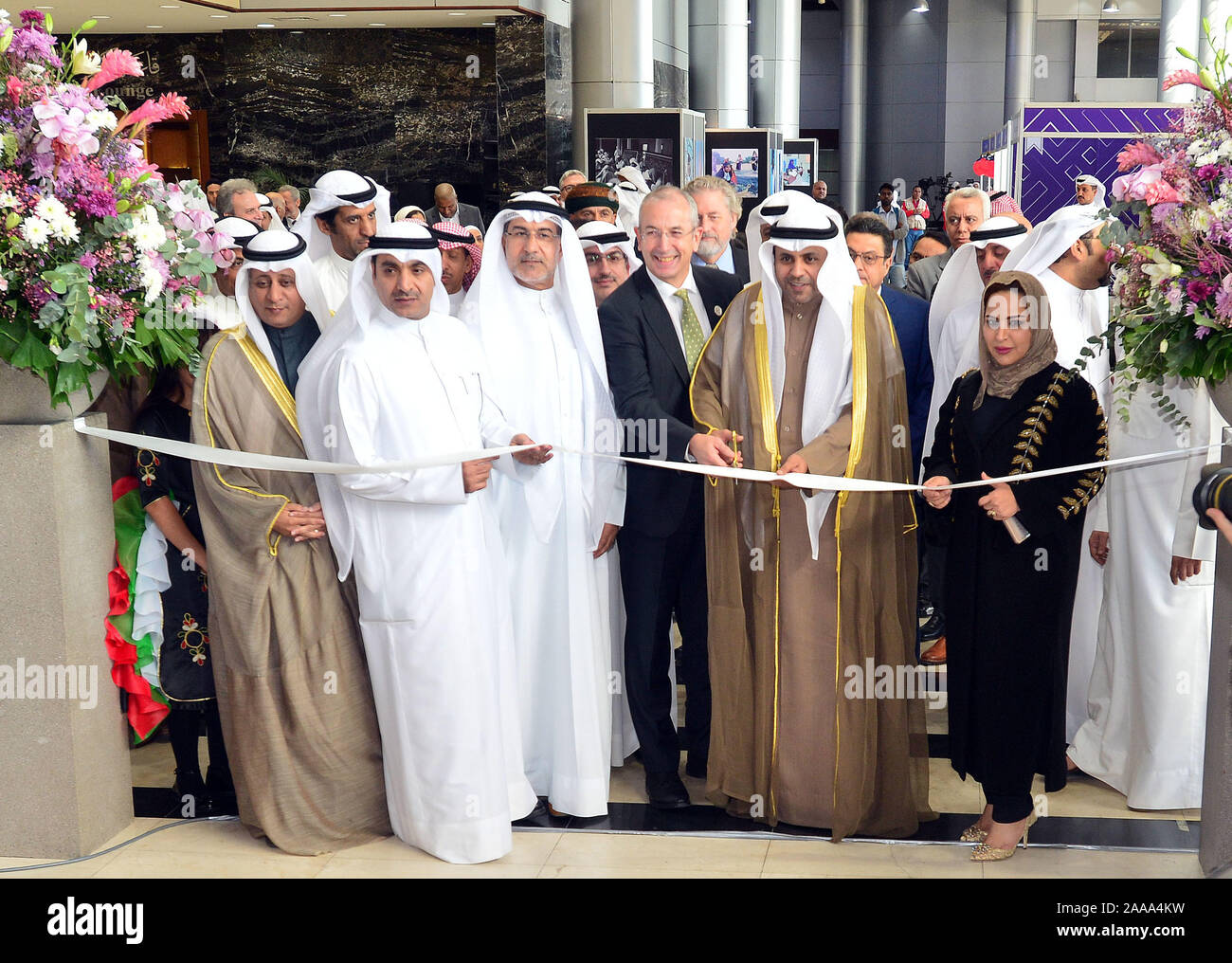 (191120) -- HAWALLI GOVERNORATE, Nov. 20, 2019 (Xinhua) -- Mohammad Al-Jabri (2nd R, Front), Kuwaiti Minister of Information and Minister of State for Youth Affairs, cuts the ribbon during the opening ceremony of the 44th Kuwait International Book Fair in Hawalli Governorate, Kuwait, on Nov. 20, 2019. The 44th Kuwait International Book Fair kicked off on Wednesday at the Kuwait International Fairground. Three Chinese publishing houses participated in the book fair. (Photo by Asad/Xinhua) Stock Photo