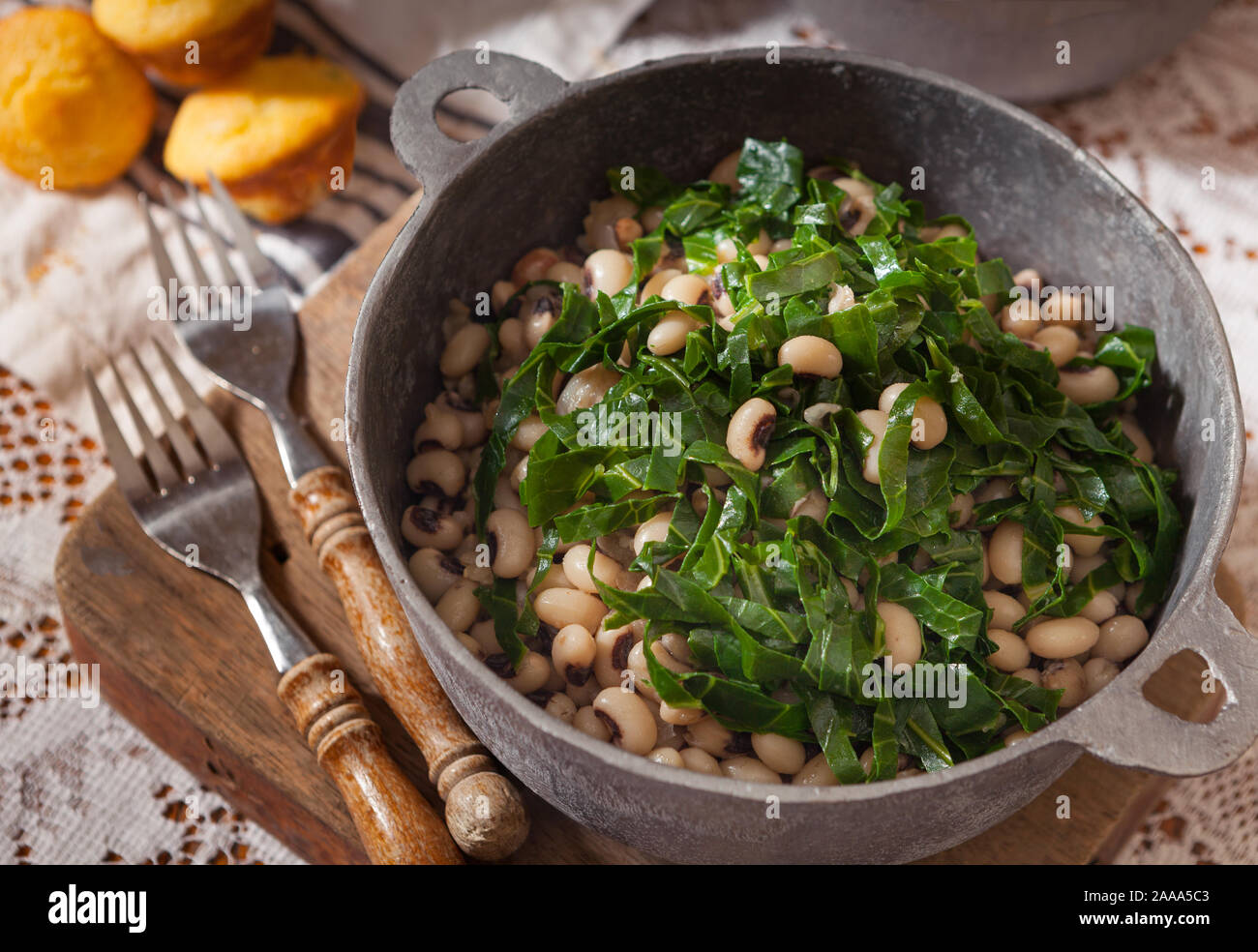US Southern dish of black eyed peas and collard greens with corn brread Stock Photo Alamy