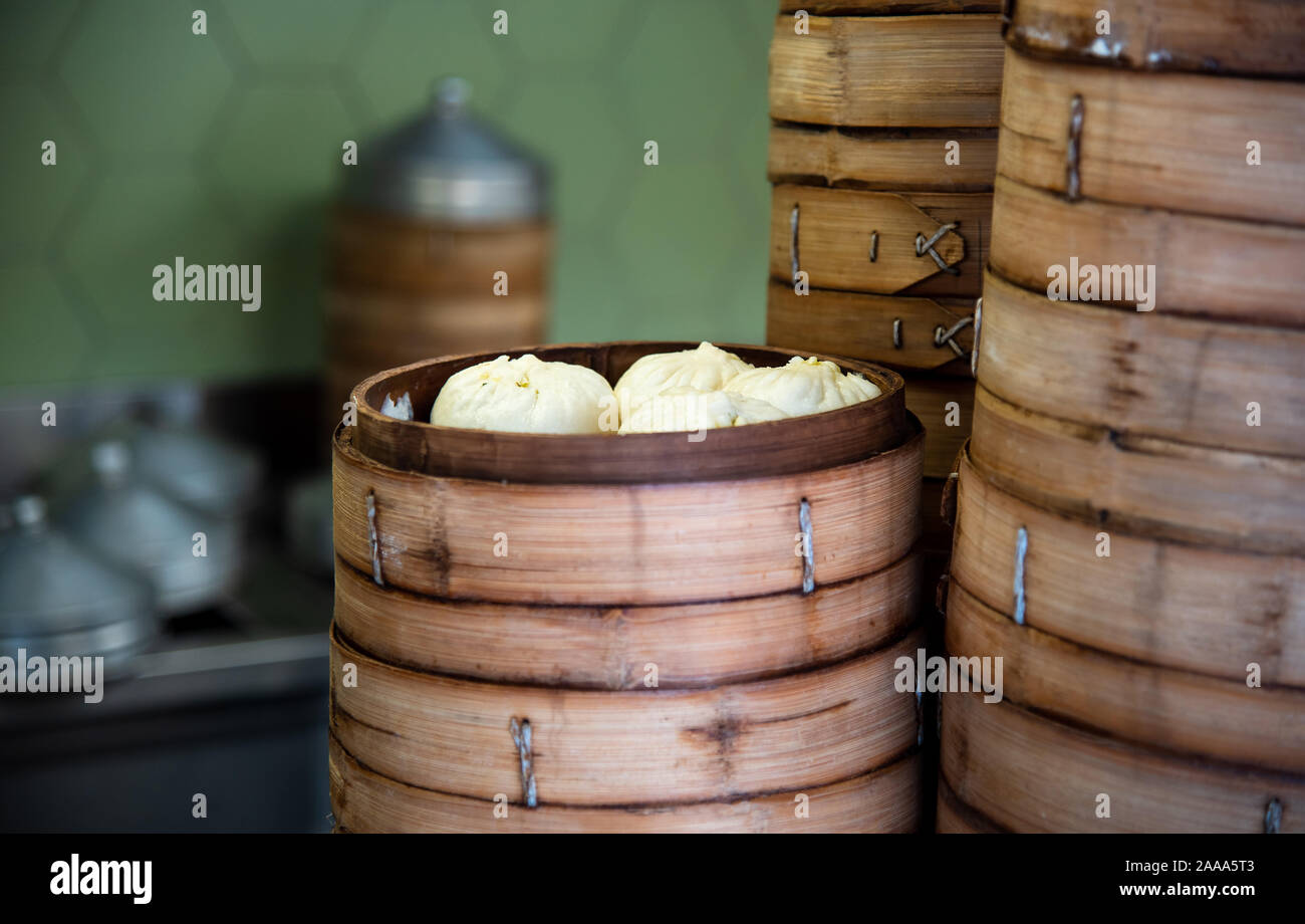 Fresh baozi in bamboo steamer on Chinese Asian food street Stock Photo