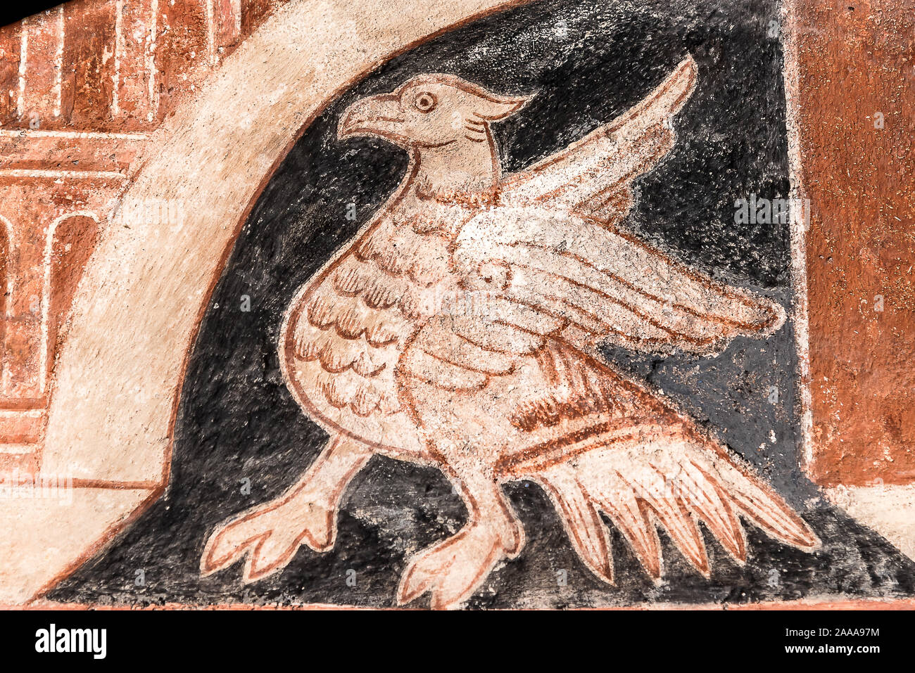 A mythical creature with the head and wings of an eagle, a medieval fresco in Skibby church, Denmark, November 20, 2019 Stock Photo