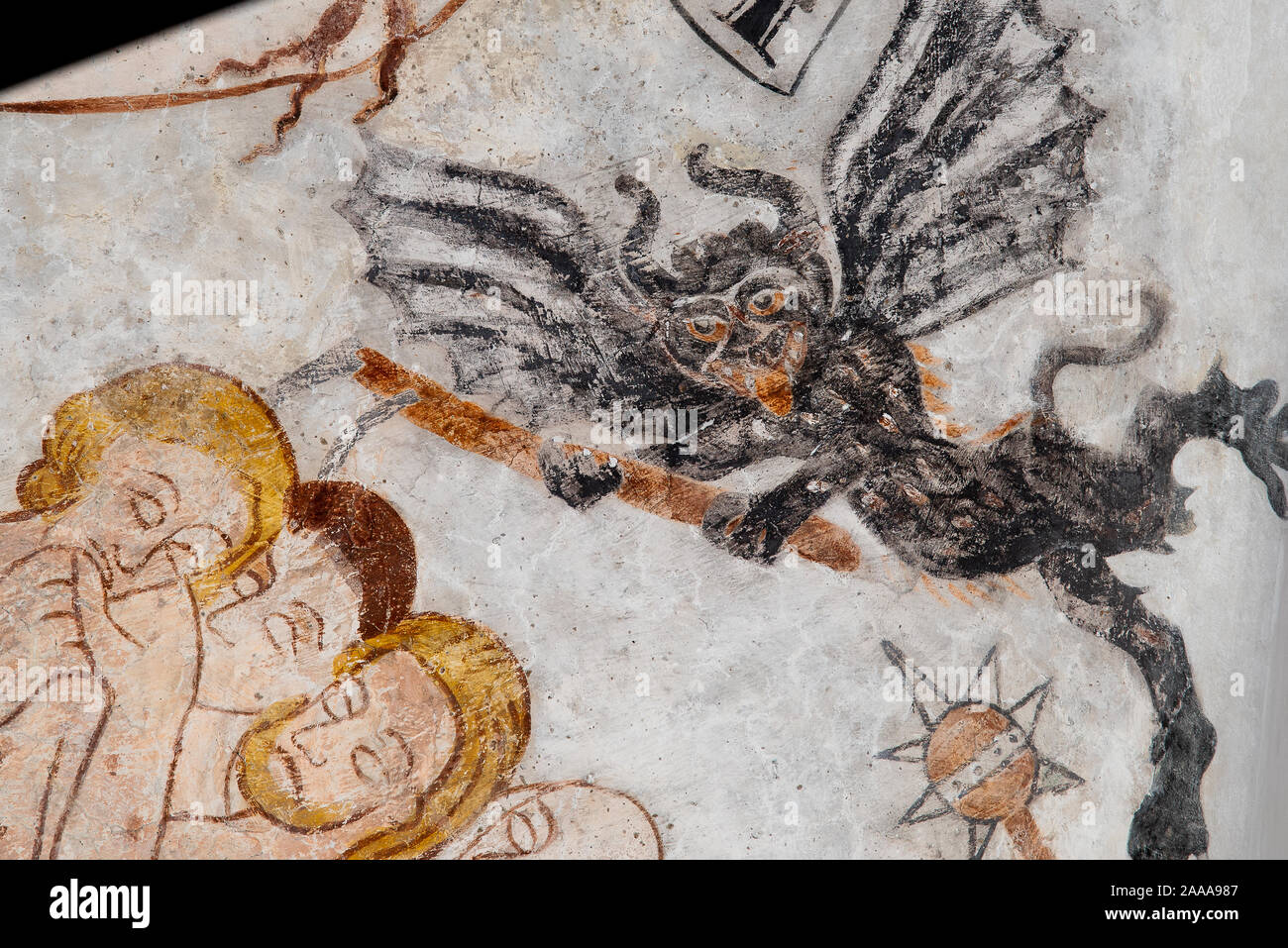 a flying devil with bat-wings attacks some people, a medieval fresco in Skibby church, Denmark, November 20, 2019 Stock Photo