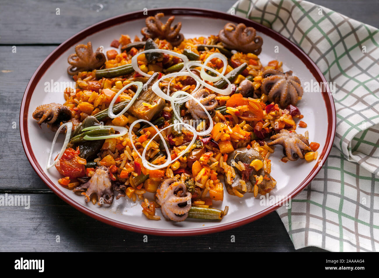 Close-up Traditional spanish paella with octopuses. Mediterranean food. Ketogenic Diet Recipes Stock Photo