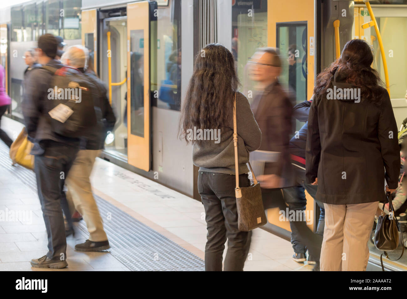 Commuting people getting on and off a Waratah Series Sydney train at