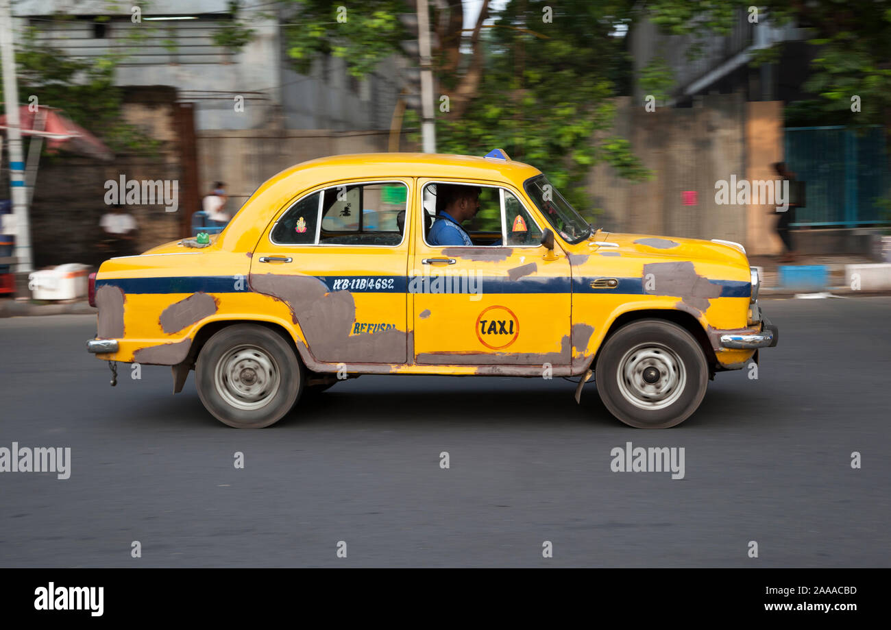 Battered Ambassador taxi races through the streets of Kolkatta, (Calcutta), India Stock Photo
