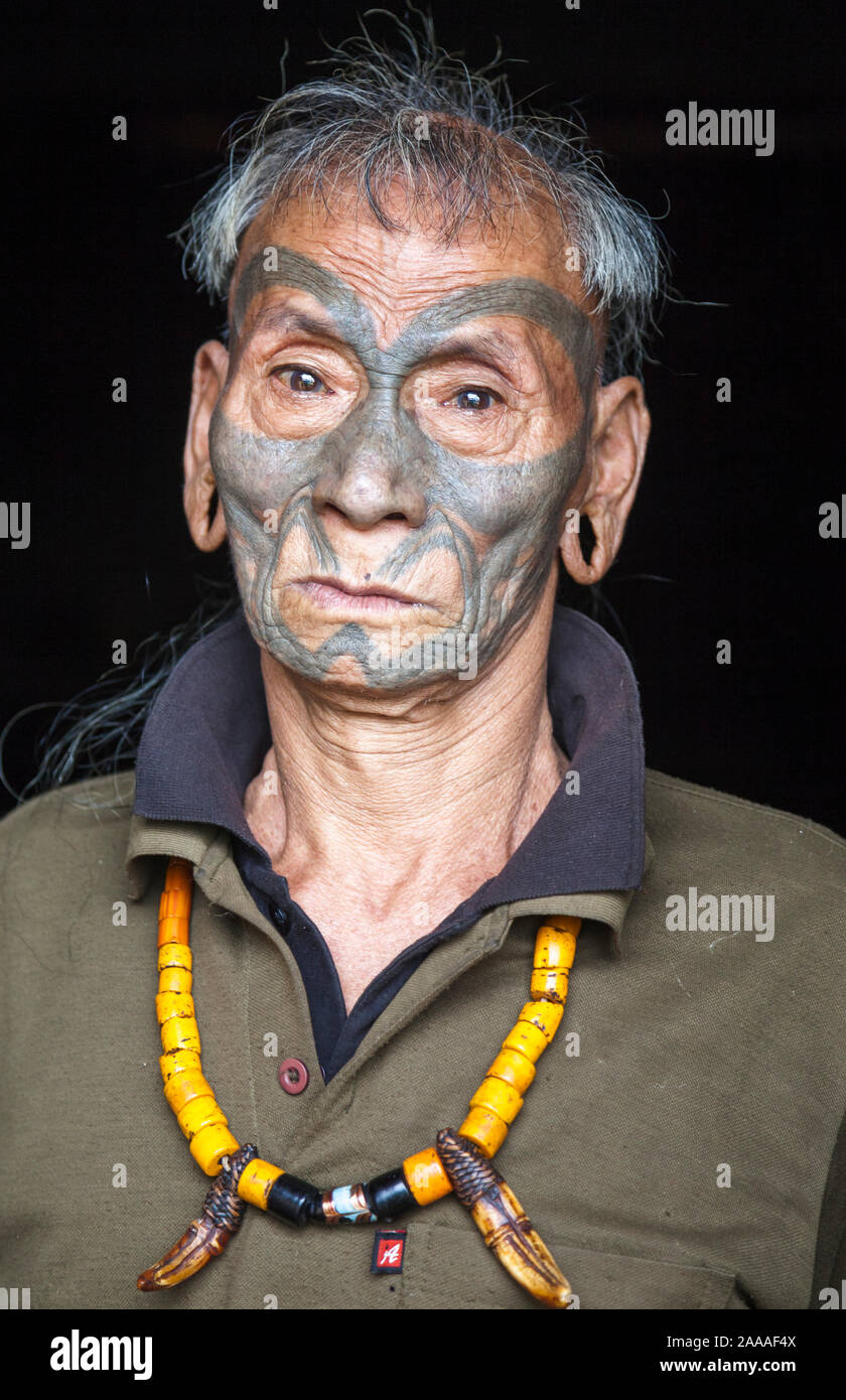 Former headhunter and village elder of the Konyak tribe with tattooed face, Nagaland, Eastern India Stock Photo