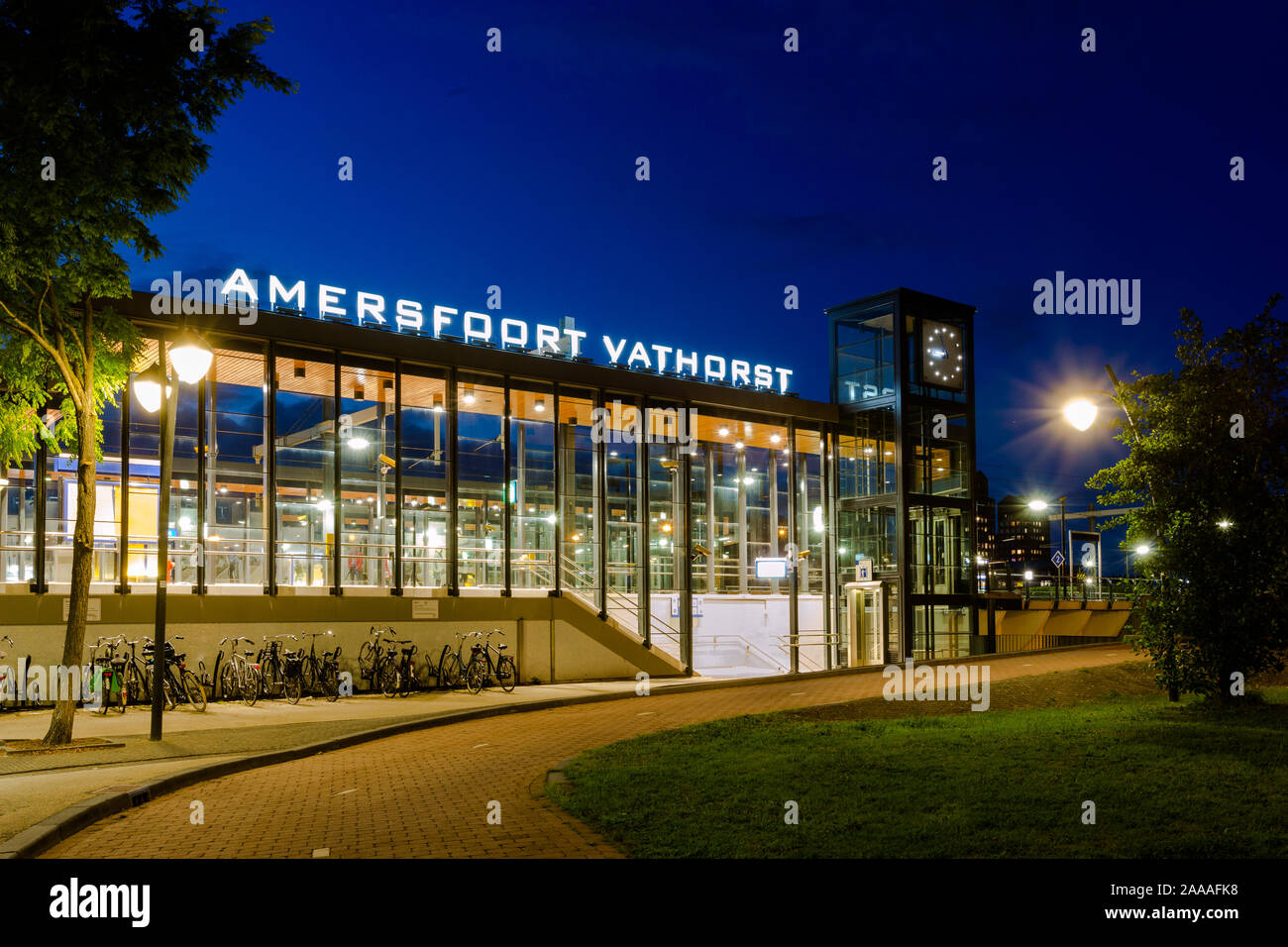 AMERSFOORT, THE NETHERLANDS - September 08, 2019: Illuminated train station Amersfoort Vathorst during blue hour with empty platform and parked bikes Stock Photo