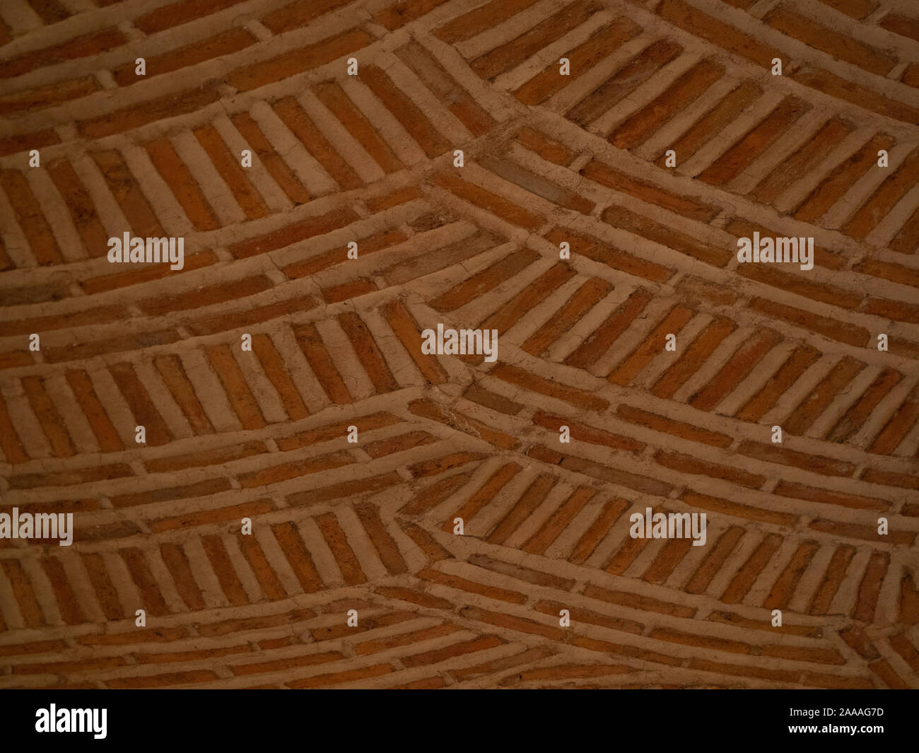 Tan or terracotta-colored brick with thick mortar in an arcing pattern ...