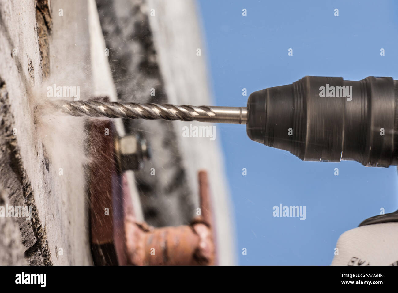 power drill drilling through hard concrete Stock Photo Alamy