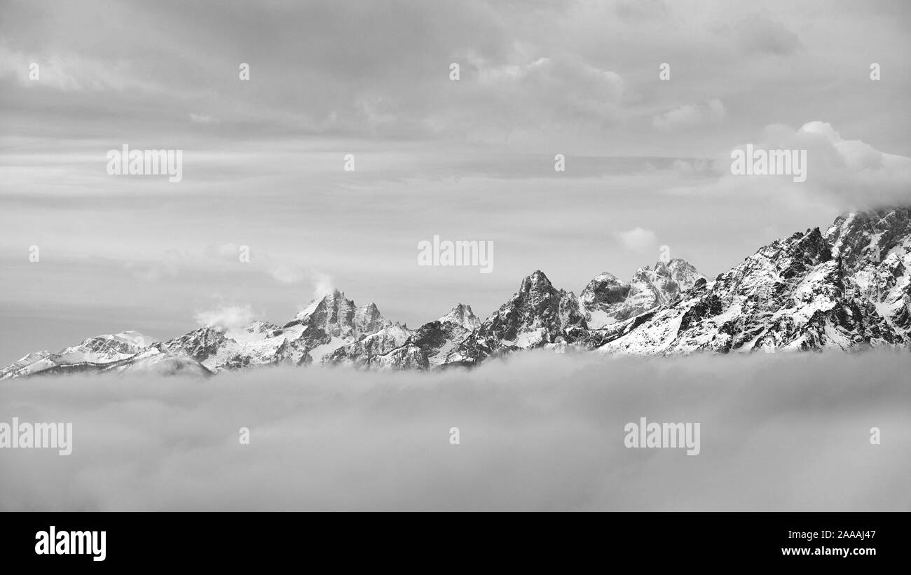 Black and white picture of Grand Teton mountain range in clouds, Wyoming, USA. Stock Photo
