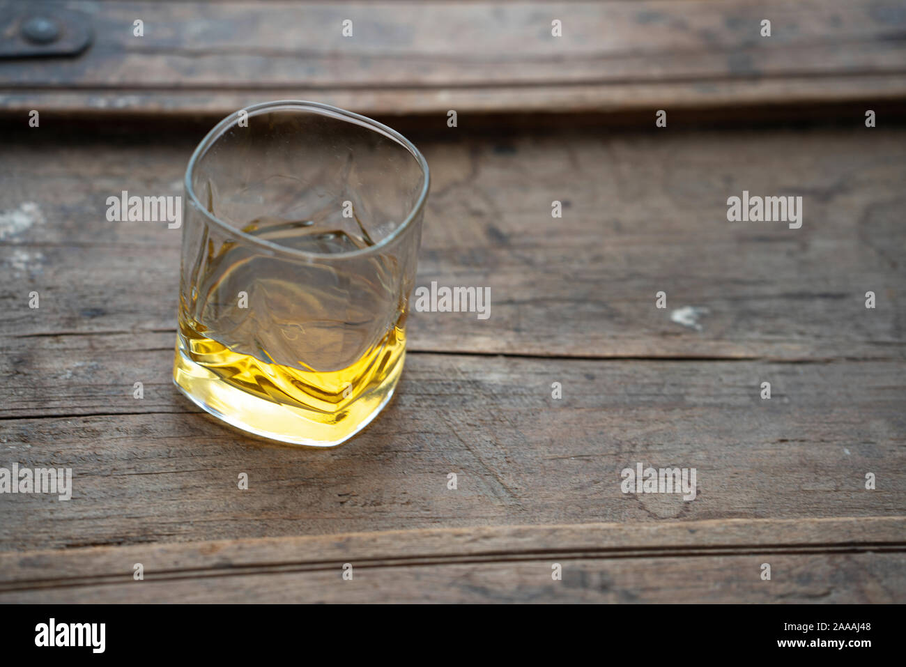 Bourbon whiskey in crystal glass garnished with ice, water droplets on side  of cup, with exquisite upscale bar background, blurred background focused  on glass on Craiyon