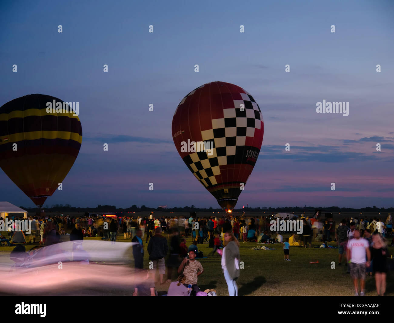 SZEGED, HUNGARY - SEPTEMBER 14, 2019: View on the hot air balloons before  the takeoff on the Szeged Airport with the crowd of the attendees of the  eve Stock Photo - Alamy