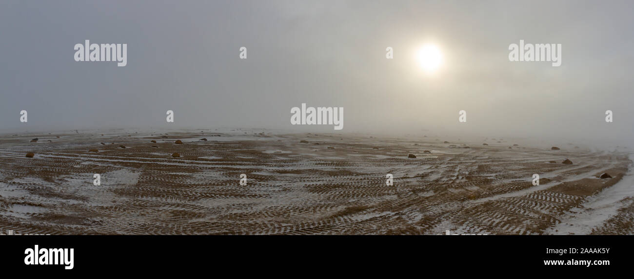 Panorama of tundra landscape in winter with tracks of rover vehicles on Hudson Bay near Churchill, Manitoba, Canada. Stock Photo