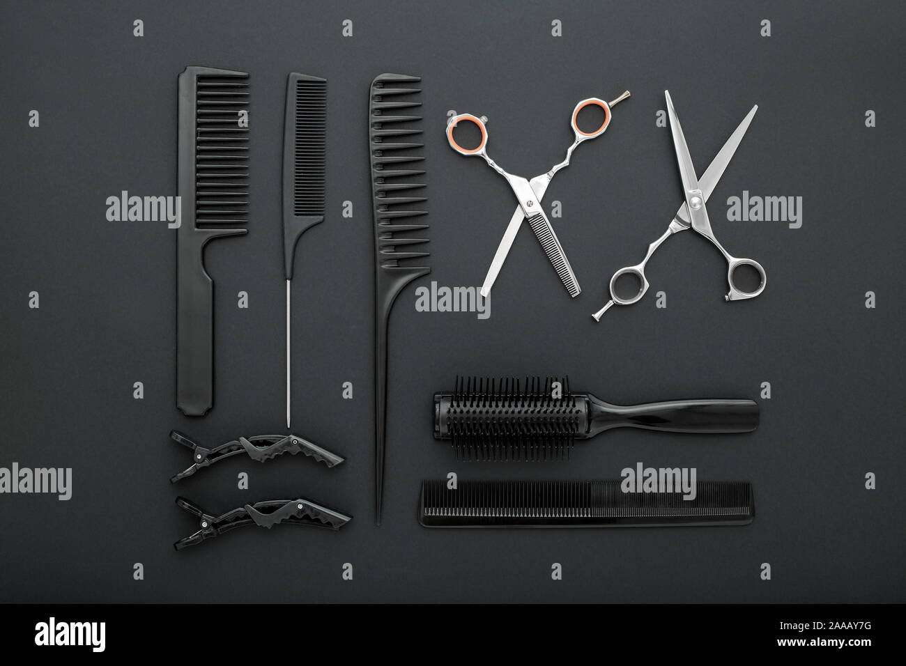 Flat lay composition with Hairdresser tools scissors, combs, hair iron