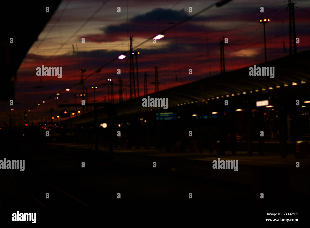 The night lights of a railway station during the sunset. Stock Photo