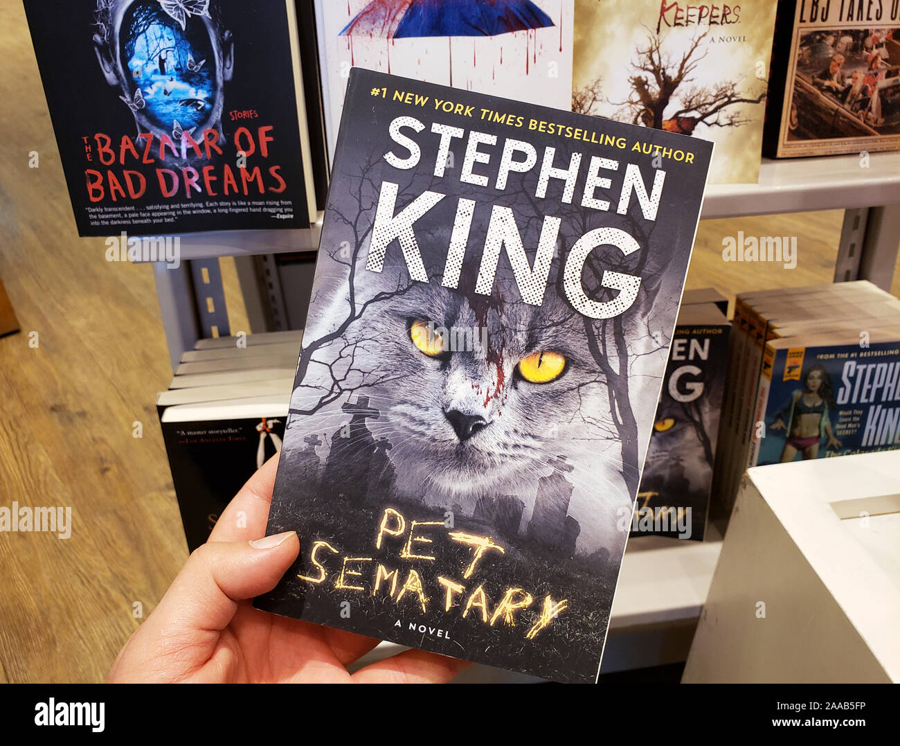 Montreal, Canada - October 23, 2019: A hand holding a Stephen King book Pet Sematary. Stephen King is an American famous author of supernatural fictio Stock Photo