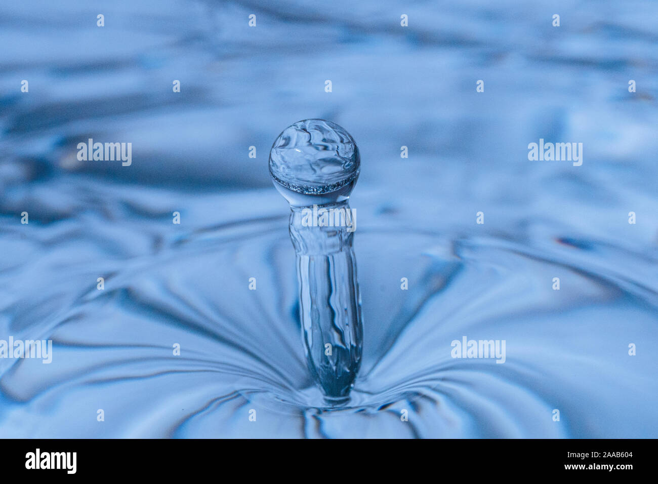 Water drop collision form metallic background Stock Photo
