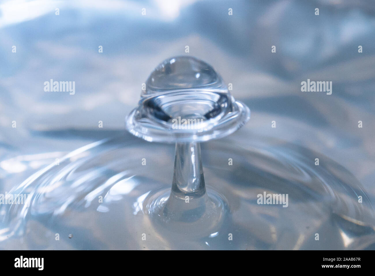 Water drop collision form metallic background Stock Photo