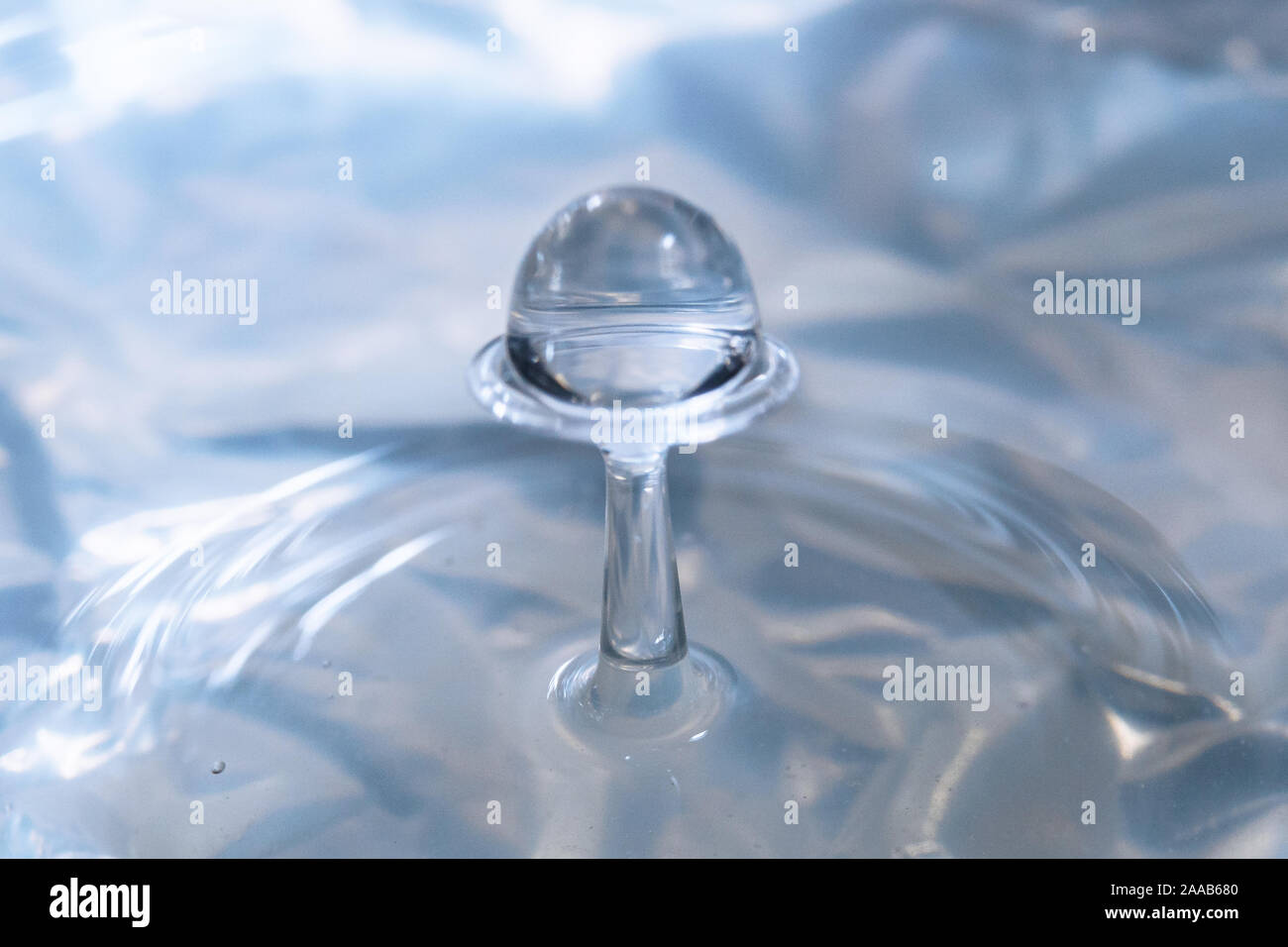 Water drop collision form metallic background Stock Photo
