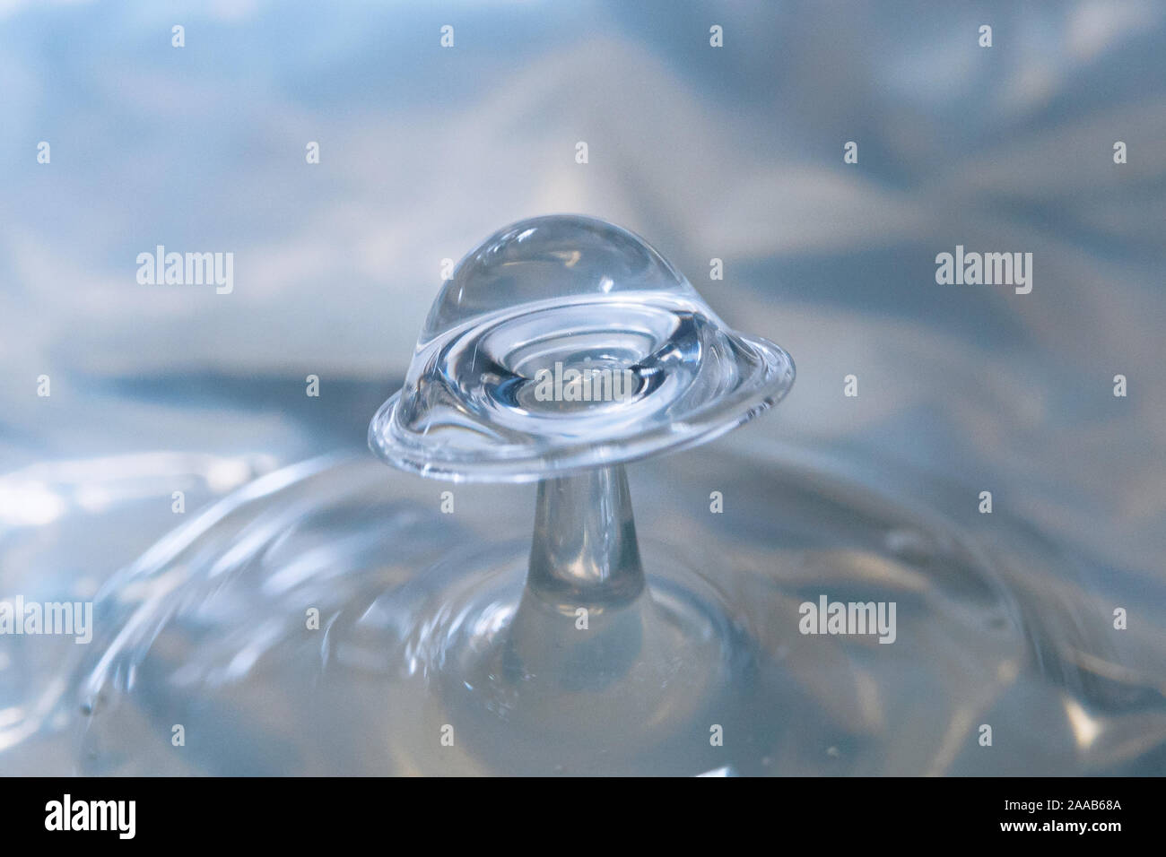 Water drop collision form metallic background Stock Photo