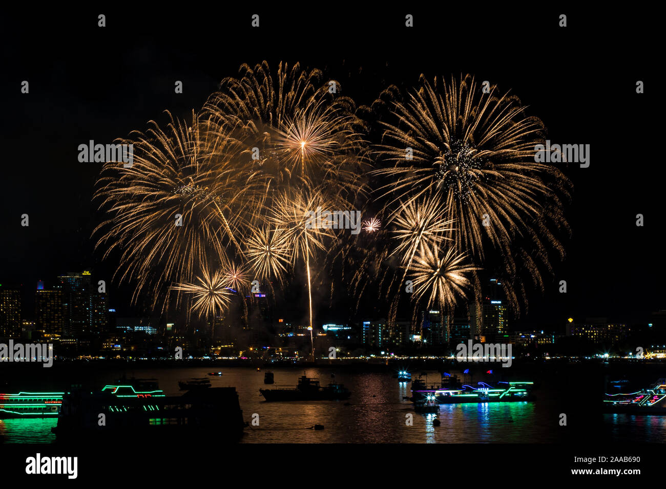 Fireworks over cityscape by the beach and sea surrounding with hotels ...