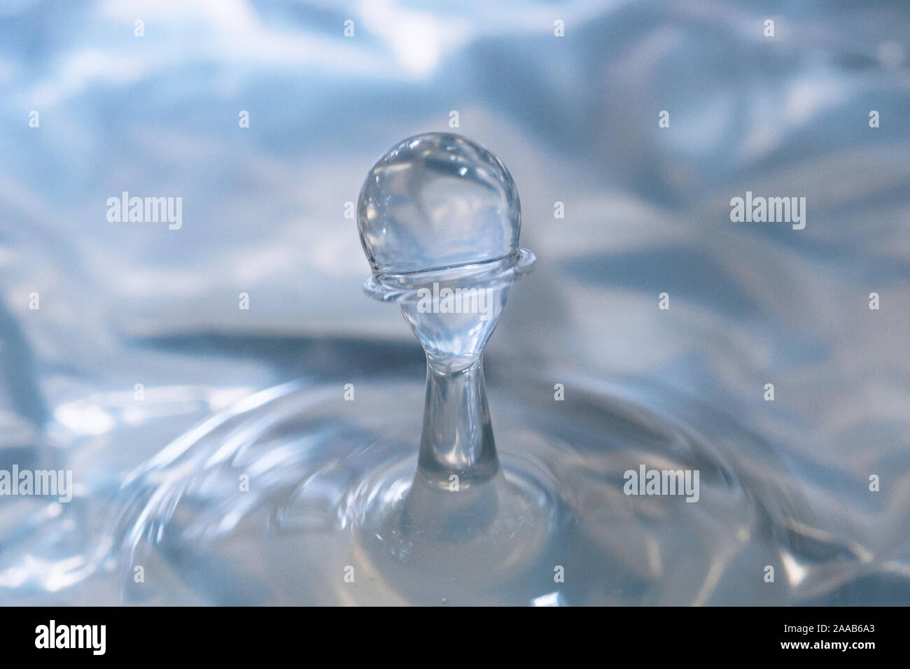 Water drop collision form metallic background Stock Photo