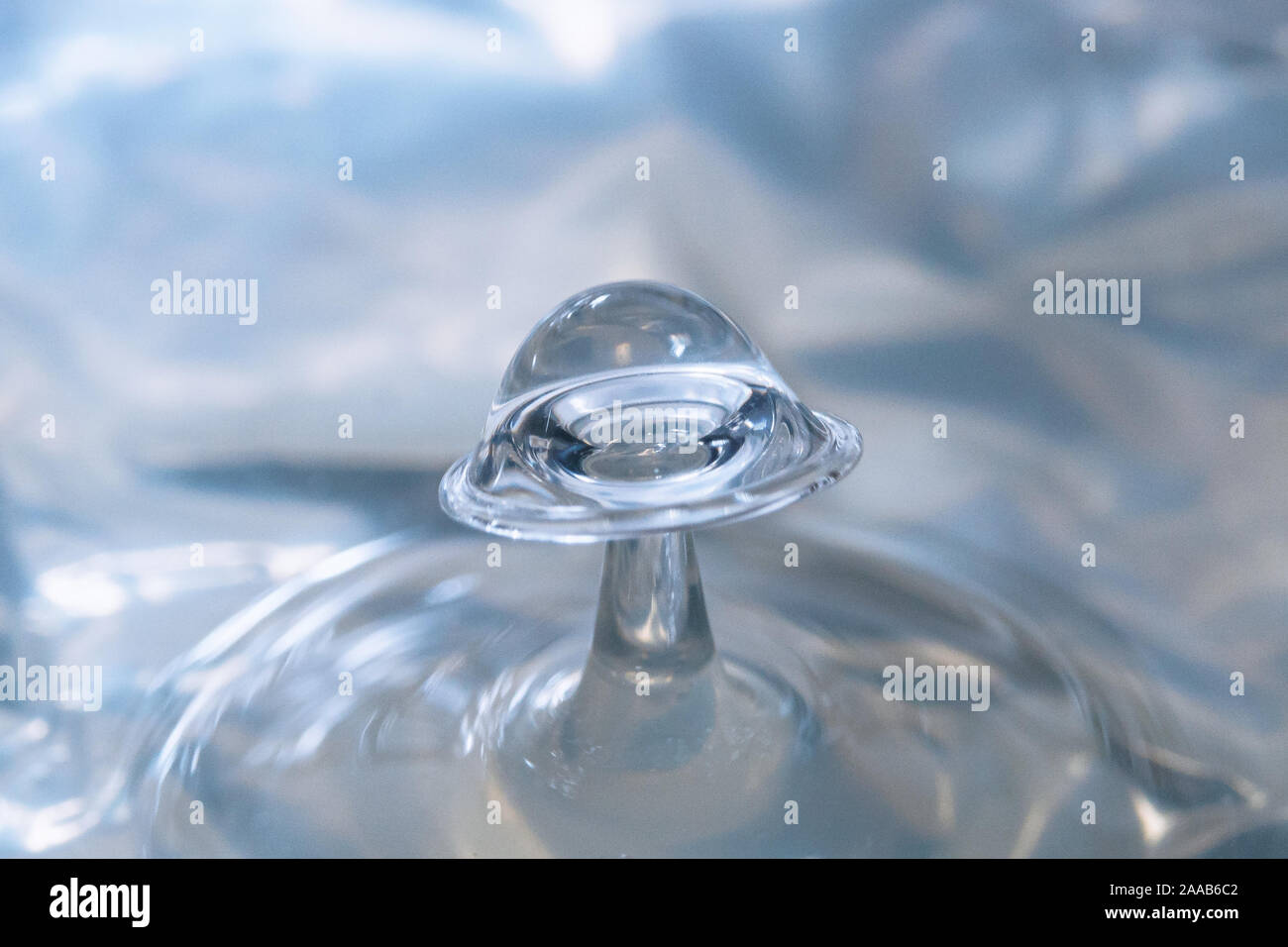 Water drop collision form metallic background Stock Photo