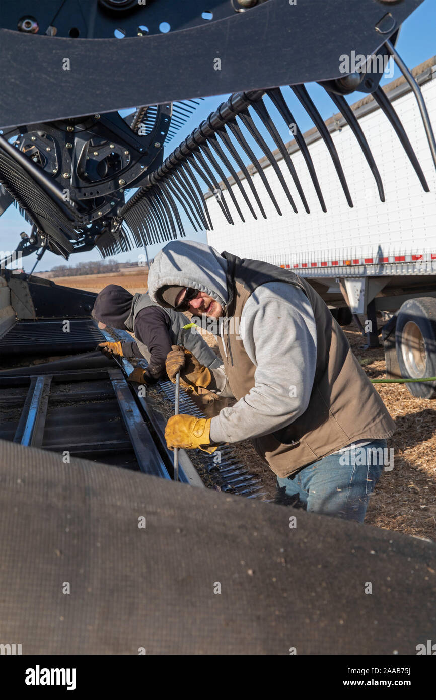 Valley City, North Dakota Workers clean a combine being used to