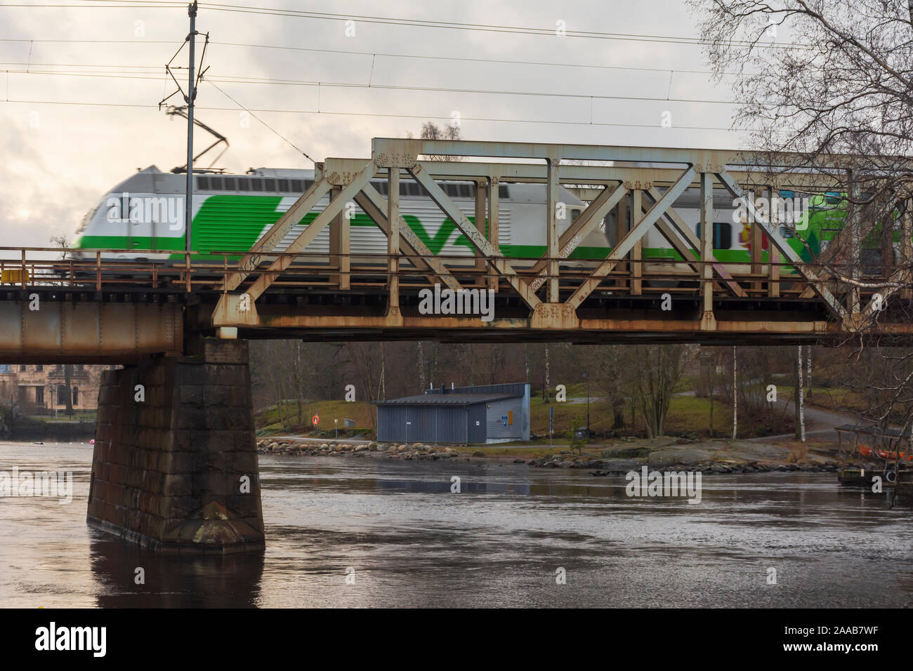 Train on Iron railroad bridge in Tampere Finland Stock Photo