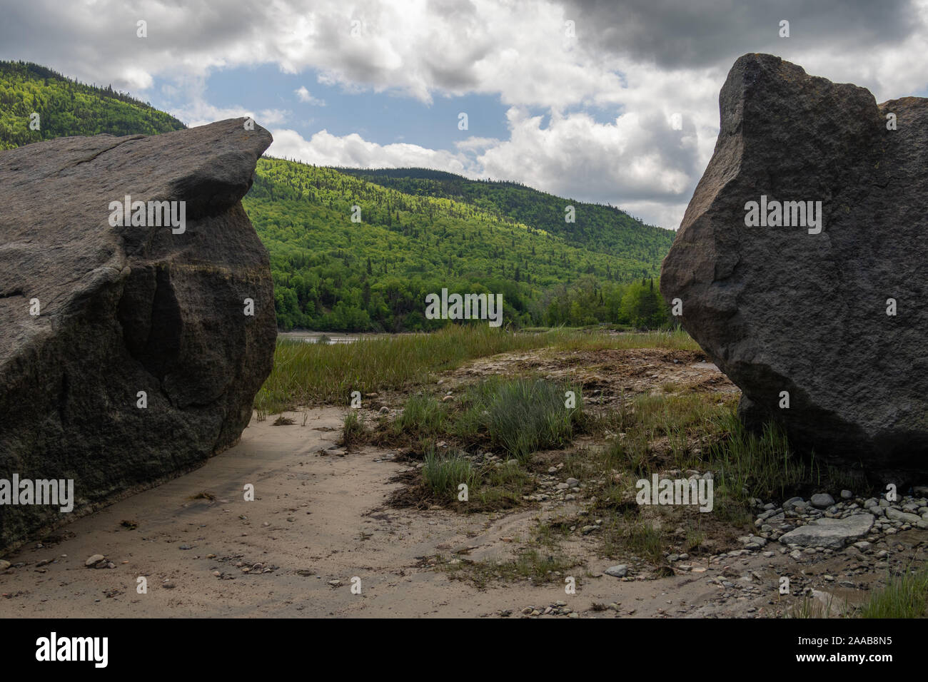 Huge rocks framing a beach landscape in Saguenay region of Quebec Stock Photo