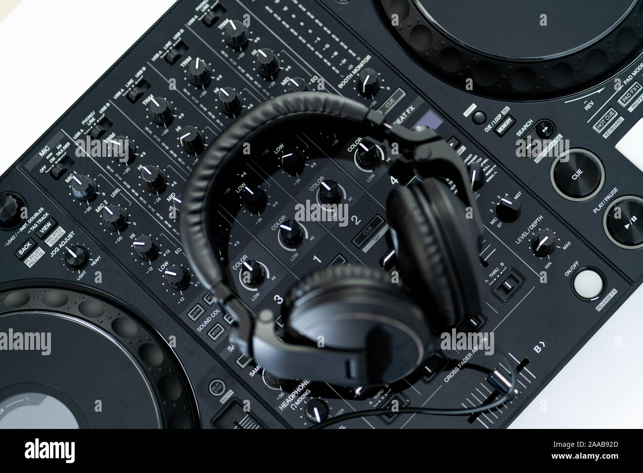 Party dj headphones with powerful bass.Equipment for nightclub.Disc jockey digital cd player turntable.Play music on hip hop parties.Light leak effect Stock Photo