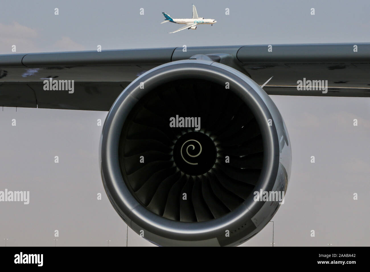 Dubai, United Arab Emirates. 18th Nov, 2019. The Airbus A330 neo widebody jetliner flies with a jet engine on the foreground displayed during the second day of the Dubai International Airshow-2019. Credit: SOPA Images Limited/Alamy Live News Stock Photo