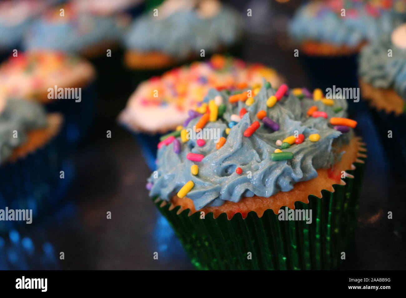Delicious cupcakes with blue and white frosting with sprinkles Stock Photo