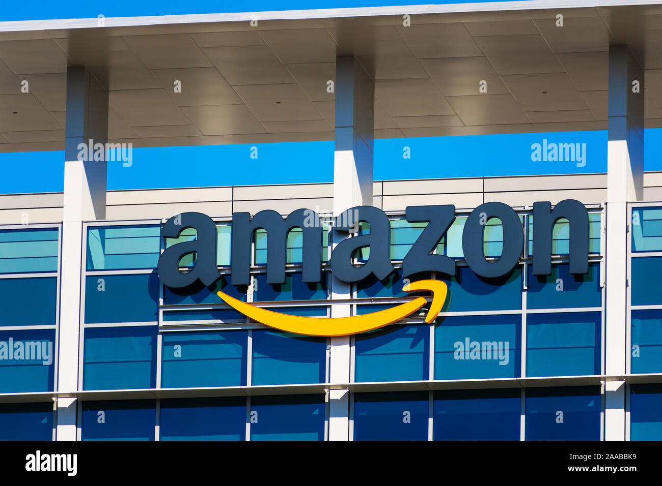 Amazon logo with its signature orange smile on facade of modern company campus - Palo Alto, California, USA - 2019 Stock Photo