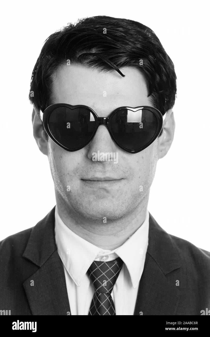 Face of handsome businessman wearing heart shaped sunglasses Stock Photo