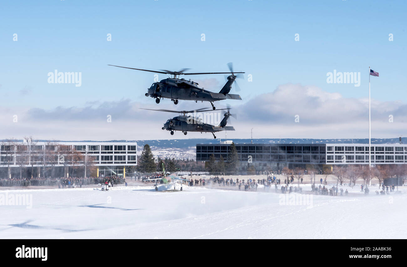 U.S. AIR FORCE ACADEMY, Colo. – Two HH-60 helicopters hover above the snow covered Terrazzo on the U.S. Air Force Academy Nov. 1, 2019 during an airpower demonstration. The demonstration included an assortment of aircraft from fighter jets to helicopters, including a CV-22 Osprey. (U.S. Air Force photo/Trevor Cokley) Stock Photo