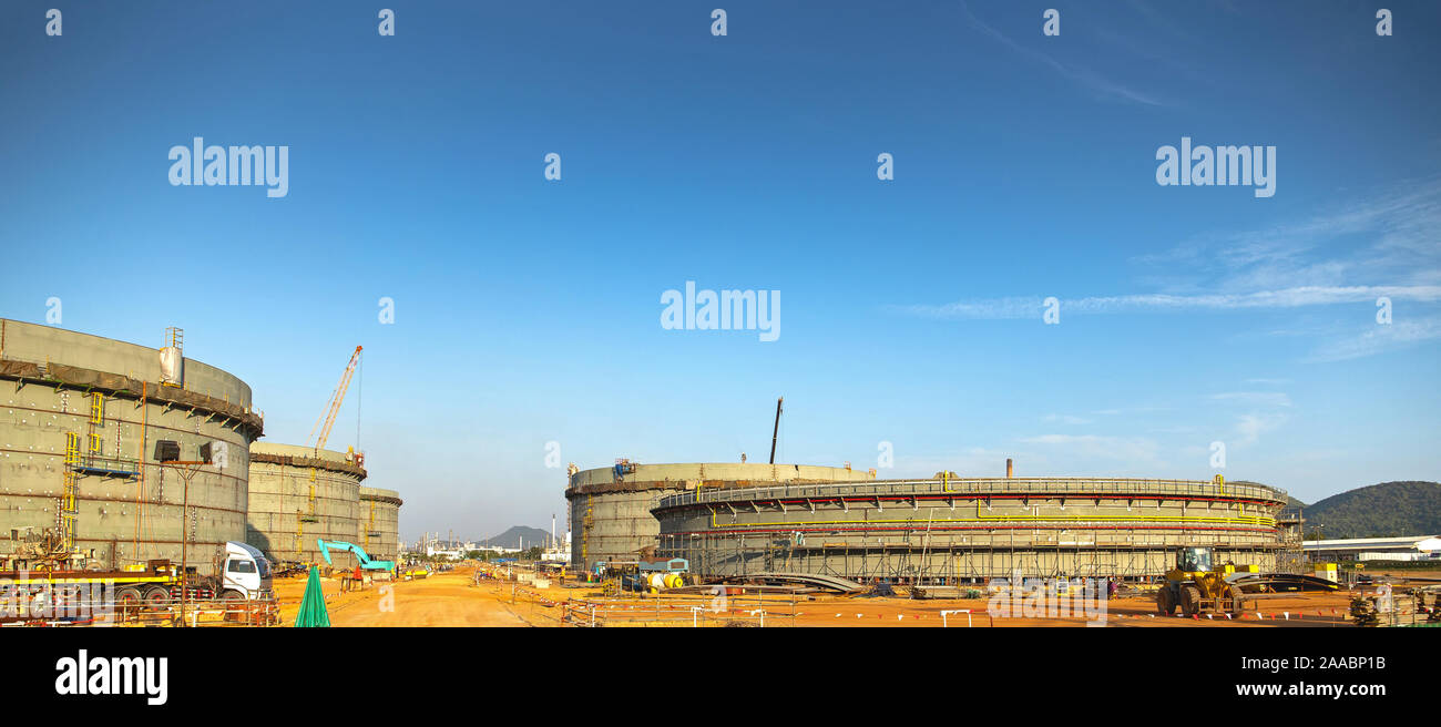 Construction site of Oil and gas industrial, Huge oil storage tank ,Heavy construction machine doing building  with the workers. Stock Photo