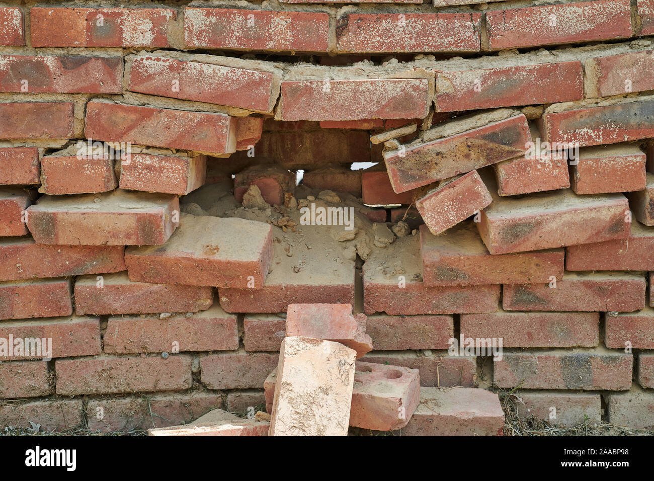 Large hole in the brick wall Stock Photo