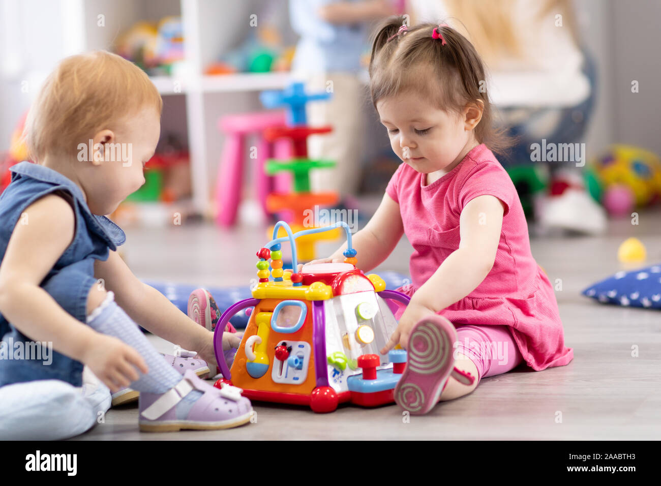 Children play together in kindergarten or day care centre Stock Photo
