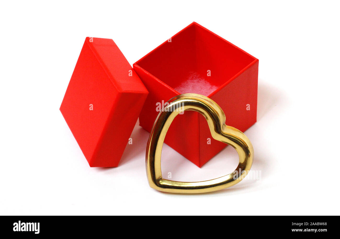 Red gift box with an open lid on a white background. There is a place for text. Bright red box without inscriptions. Nearby is a golden heart. Gift fo Stock Photo