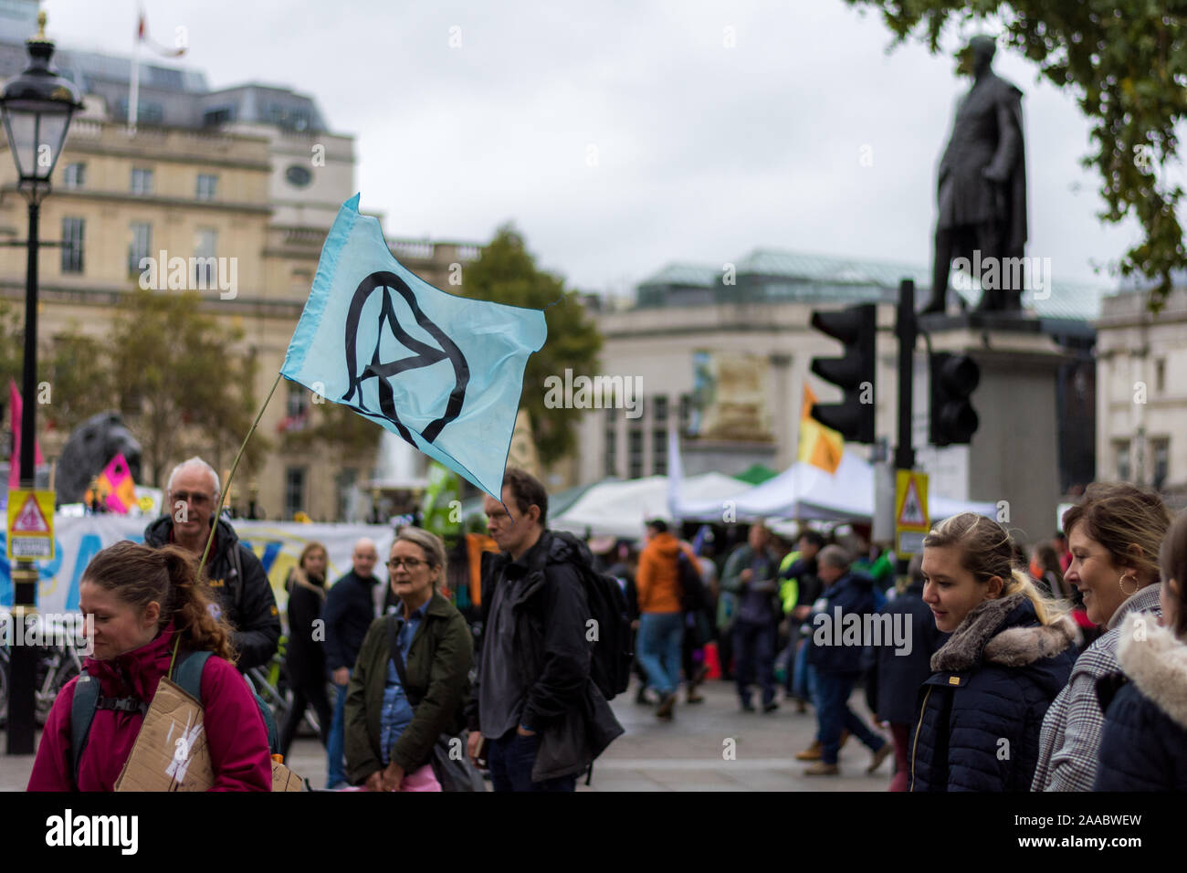 London, England –October 11, 2019:  Extinction Rebellion protesters in Trafalgar Square London holding flags and protesting against climate change Stock Photo